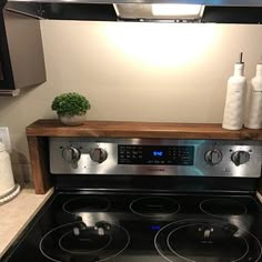 a stove with two burners in a kitchen next to a counter top and an oven hood