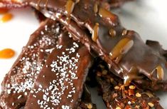 chocolate dessert with nuts and sprinkles on a white plate