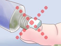 a hand holding a bottle with red dots on it and the top half of it being filled