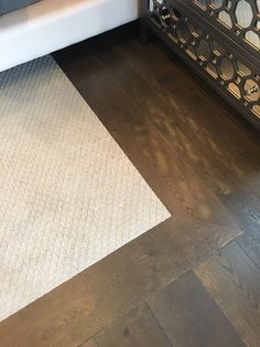 a close up of a rug on the floor in a living room with wood floors