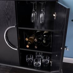 a cabinet with wine glasses and bottles in it