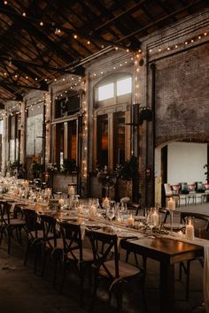 a long table is set with candles and place settings