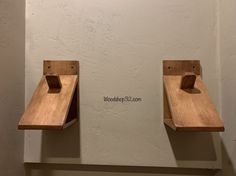 two wooden shelfs are on the wall