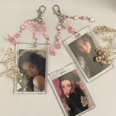 two keychains with pictures of women on them, one is pink and the other is white