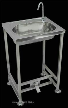 a stainless steel sink and stand with faucet