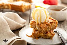 a piece of cake on a plate with ice cream and caramel drizzle