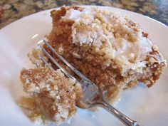 a close up of a piece of cake on a plate with a fork in it