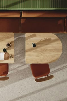 an overhead view of two wooden tables with chairs and a laptop on one side, in front of a bench