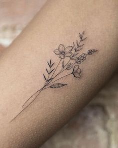 a woman's arm with a flower tattoo on the left side of her body