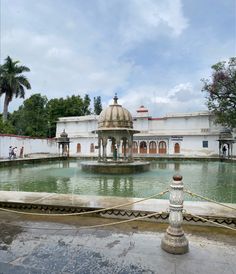 an old building with a fountain in front of it