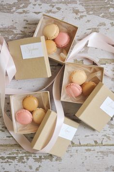 two boxes with macaroons in them sitting next to each other