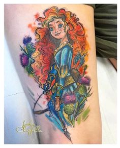 a woman with long red hair holding a bow and arrow tattoo on her thigh,