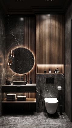 a modern bathroom with marble walls and flooring, including a round mirror above the sink