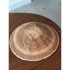 a straw hat sitting on top of a wooden table