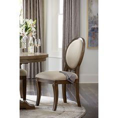 a dining room table and chairs in front of a window