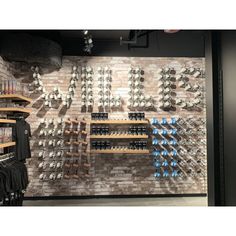 the wine cellar is full of bottles and racks with glasses hanging on it's walls