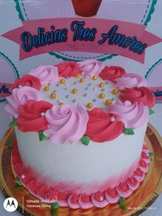 there is a cake that has pink flowers on it