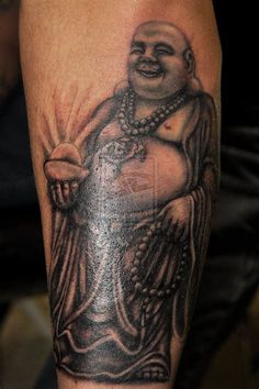 a man with a buddha tattoo on his arm