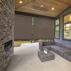 an outdoor living area with couches and windows