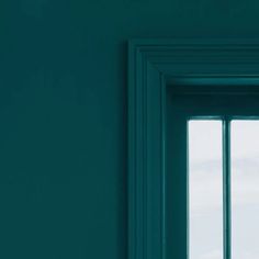 an open window in a room with green walls