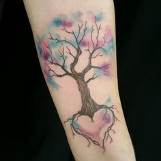 a watercolor tree tattoo on the arm