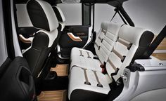 the interior of a car with white and black leather seats