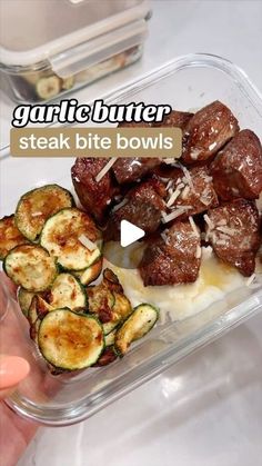 someone is holding a container with food in it and the words garlic butter steak bite bowls