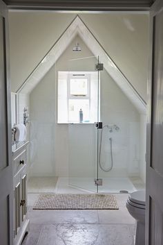 an instagram photo of a bathroom with white walls and floors, including a shower