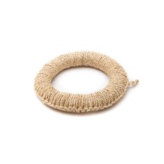 a bracelet made out of jute on a white background, with the clasp undone