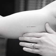 a woman's arm with a small tattoo on the left side of her arm