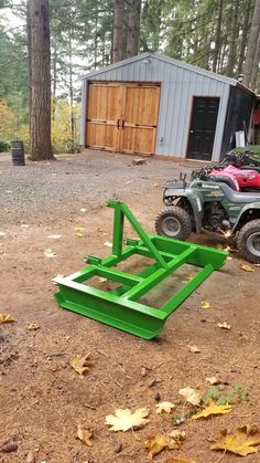 two atvs parked next to each other in front of a building with trees and leaves on the ground