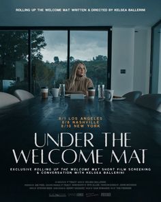 a woman sitting at a table in front of a window with the words under the welcome mat on it