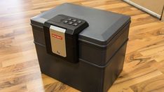 a large black box sitting on top of a hard wood floor