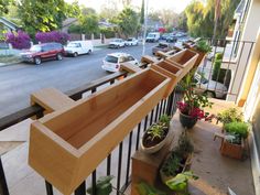 wooden planters are lined up along the railing