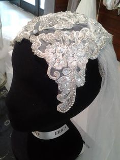 a bridal hat is displayed on a mannequin's headdress