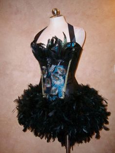 a mannequin wearing a black and blue corset with feathers on it