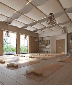 an empty room with yoga mats on the floor