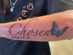 a person with a tattoo on their arm that says chosen and two butterflies in the background