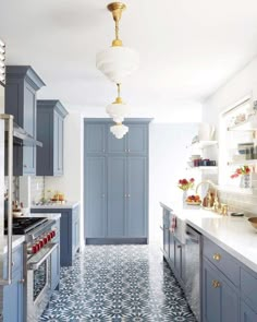 a kitchen with blue cabinets and white counter tops on instagramting from an instagramtor