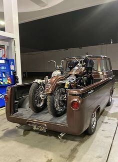 an old truck with two motorcycles in the back