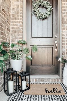 the front door is decorated with plants and candles