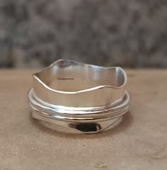 a silver ring sitting on top of a table