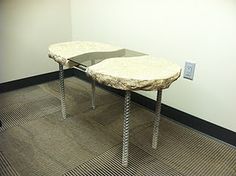 a table that is sitting in the middle of a room with two legs on it