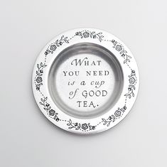 a metal plate with the words what you need is a cup of tea on it