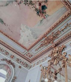 the ceiling is painted in pink and gold