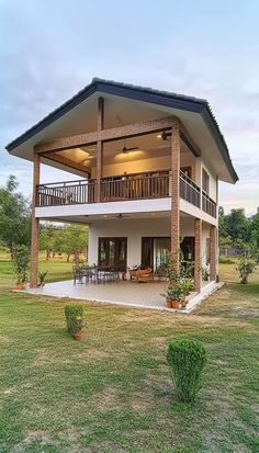 a large house sitting on top of a lush green field