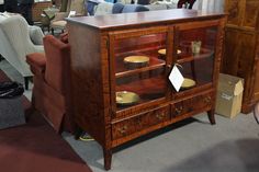 a wooden cabinet sitting on top of a carpeted floor