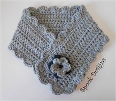 a crocheted sweater with a flower on it