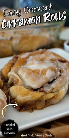 cinnamon rolls are sitting on a white plate