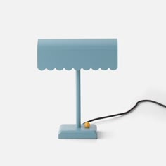 a blue table lamp with a black cord connected to it